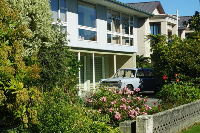 Modern house with a classic car parked outside.